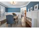 Elegant dining room featuring wainscoting, stylish blue walls, hardwood floors, and a dining set at 1637 Duncan Nw Dr, Atlanta, GA 30318