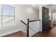 Upstairs hallway with hardwood flooring and a staircase visible through a window at 1637 Duncan Nw Dr, Atlanta, GA 30318