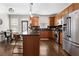 Modern kitchen featuring stainless steel appliances, wooden cabinets, and a stylish island with seating at 1637 Duncan Nw Dr, Atlanta, GA 30318