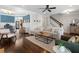 Bright living room with hardwood floors, a ceiling fan, and an open layout connecting to the dining area at 1637 Duncan Nw Dr, Atlanta, GA 30318