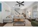 Inviting living room with a sectional sofa, hardwood floors, and a staircase, creating a comfortable atmosphere at 1637 Duncan Nw Dr, Atlanta, GA 30318