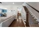 Open-concept living room with hardwood floors, a staircase, and a view into the dining area at 1637 Duncan Nw Dr, Atlanta, GA 30318