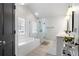 Main bathroom featuring a glass-enclosed shower, a soaking tub, and double sinks at 1637 Duncan Nw Dr, Atlanta, GA 30318