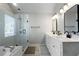 Bright main bathroom with double sinks, a soaking tub, and a glass-enclosed shower at 1637 Duncan Nw Dr, Atlanta, GA 30318