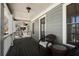 View of porch with a wicker chair, a wicker table, grey siding, white trim, and a stained wood deck at 1637 Duncan Nw Dr, Atlanta, GA 30318