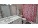 Bright bathroom featuring a single sink vanity and a shower with a vibrant patterned curtain at 222 Ashford Cir # 222, Atlanta, GA 30338