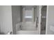 Bathroom featuring a tub/shower combination, tile surround, and a window at 222 Ashford Cir # 222, Atlanta, GA 30338