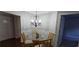 Dining area with a glass table, four chairs, and a decorative chandelier at 222 Ashford Cir # 222, Atlanta, GA 30338