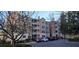 Elegant condo building with multiple stories, white balconies, and well-maintained landscaping at 222 Ashford Cir # 222, Atlanta, GA 30338