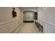 Hallway with paneled walls, tile flooring, and a cozy wooden bench at 222 Ashford Cir # 222, Atlanta, GA 30338