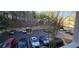 A partial view of a parking lot with several cars, set among lush green trees at 222 Ashford Cir # 222, Atlanta, GA 30338