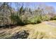 Wide backyard with sparse trees and vegetation at 2971 Ruby Ct, Powder Springs, GA 30127