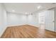 Finished basement space with modern wood-look floors, recessed lighting, and an open doorway at 3182 Glynn Mill Dr, Snellville, GA 30039