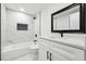 Contemporary bathroom showcasing white marble tile, a black-framed mirror, and modern fixtures at 3182 Glynn Mill Dr, Snellville, GA 30039