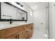 Elegant bathroom with double vanity, wood cabinets, and a modern glass-enclosed shower at 3182 Glynn Mill Dr, Snellville, GA 30039