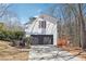 Attached garage with a dark gray door, wood deck, and plenty of driveway space at 3182 Glynn Mill Dr, Snellville, GA 30039