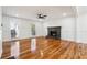 Bright living room featuring hardwood floors, brick fireplace and large windows overlooking mature trees at 3182 Glynn Mill Dr, Snellville, GA 30039