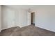 This bedroom features neutral walls, carpet, and two entry doors at 9185 Brockham Way, Alpharetta, GA 30022