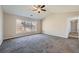 Spacious bedroom with neutral colors, large window, and ceiling fan at 9185 Brockham Way, Alpharetta, GA 30022