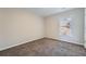 This bedroom has neutral walls, carpet and a bright window at 9185 Brockham Way, Alpharetta, GA 30022