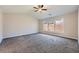 Spacious bedroom with neutral colors, large window, and ceiling fan at 9185 Brockham Way, Alpharetta, GA 30022