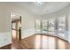 Dining room with large bay windows, hardwood floors, and elegant wainscoting at 9185 Brockham Way, Alpharetta, GA 30022