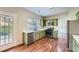 Kitchen with light green cabinets, stainless steel appliances, and views to the yard at 9185 Brockham Way, Alpharetta, GA 30022