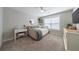 Serene bedroom with plush carpeting, a cozy daybed, and a bright window at 17 Baral Rdg, Sharpsburg, GA 30277