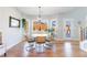 Bright dining room with hardwood floors, a modern chandelier and a large window offering scenic outdoor views at 17 Baral Rdg, Sharpsburg, GA 30277