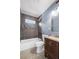 Updated bathroom featuring stylish gray tile, a shower-tub combo, and a modern vanity sink at 2006 Conrad Se Ave, Atlanta, GA 30315