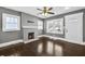 Inviting living room features a brick fireplace, ceiling fan, and gleaming hardwood floors at 2006 Conrad Se Ave, Atlanta, GA 30315
