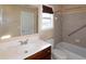 Bathroom with cherry wood cabinet, white sink and white toilet at 3285 Warbler Way, Cumming, GA 30041