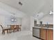 Bright dining area adjacent to the kitchen, featuring a modern chandelier and natural light at 8424 Somerton Cir, Douglasville, GA 30134