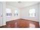 Bright, empty bedroom with hardwood floors and two windows at 1073 Oakland Drive Sw Dr, Atlanta, GA 30310