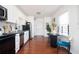 Well-lit kitchen featuring white cabinets, black appliances, and eat-in dining at 1073 Oakland Drive Sw Dr, Atlanta, GA 30310