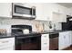 Bright kitchen features white cabinets, stainless steel appliances, and granite countertops at 1073 Oakland Drive Sw Dr, Atlanta, GA 30310