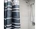 Contemporary shower with sleek fixtures and elegant black and white striped shower curtain at 1073 Oakland Drive Sw Dr, Atlanta, GA 30310