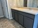 Bathroom featuring dual sinks with grey cabinetry and modern fixtures at 11978 Lovejoy Crossing Way, Hampton, GA 30228