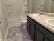 Bright bathroom featuring tub shower combo and a double sink vanity at 11978 Lovejoy Crossing Way, Hampton, GA 30228