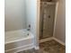 Bathroom featuring a shower and tub with modern fixtures at 11978 Lovejoy Crossing Way, Hampton, GA 30228