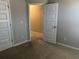 Neutral bedroom with tan carpet and white trim for a bright, inviting space at 11978 Lovejoy Crossing Way, Hampton, GA 30228