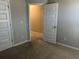 View of carpeted bedroom featuring a large closet and neutral paint scheme at 11978 Lovejoy Crossing Way, Hampton, GA 30228