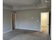 Large bedroom with carpet floors, neutral walls, and tray ceiling at 11978 Lovejoy Crossing Way, Hampton, GA 30228