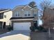 Two-story home with brick and siding, two car garage, and landscaped front yard at 11978 Lovejoy Crossing Way, Hampton, GA 30228