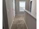 Upstairs hallway featuring carpet and an entrance to a bedroom at 11978 Lovejoy Crossing Way, Hampton, GA 30228