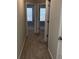 Upstairs hallway featuring carpet and multiple entrances to bedrooms at 11978 Lovejoy Crossing Way, Hampton, GA 30228