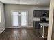 Bright kitchen and dining area with French doors, complemented by stainless steel appliances and a granite island at 11978 Lovejoy Crossing Way, Hampton, GA 30228