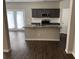 Open concept kitchen with center island and modern appliances at 11978 Lovejoy Crossing Way, Hampton, GA 30228