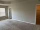 Neutral toned main bedroom with large closet and a carpeted floor at 11978 Lovejoy Crossing Way, Hampton, GA 30228