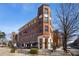 Brick building featuring a restaurant with outdoor seating under a bright blue sky at 1418 Dresden Ne Dr # 355, Atlanta, GA 30319